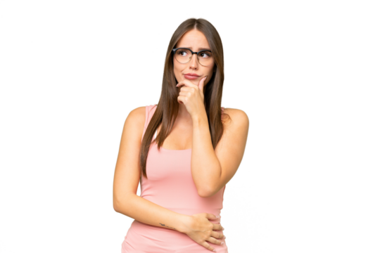 Young pretty caucasian woman over isolated background having doubts and with confuse face expression