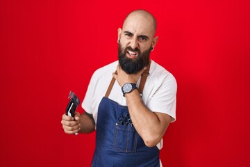Young hispanic man with beard and tattoos wearing barber apron holding razor touching painful neck, sore throat for flu, clod and infection