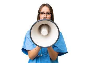 Young nurse caucasian woman over isolated background shouting through a megaphone