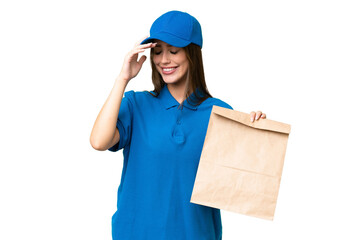 Young beautiful caucasian woman taking a bag of takeaway food over isolated background laughing