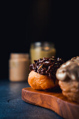 small doughnut holes with crunchy chocolate, dark moody, eye level shoot