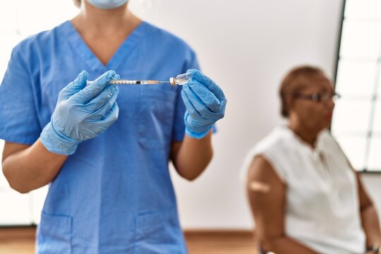 Senior african american woman patient having vaccination at clinic