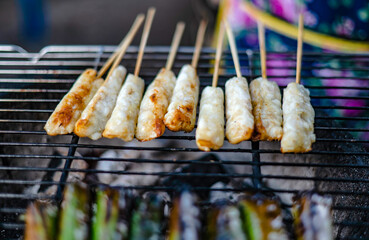 Squid eggs on skewers wrapped in banana leaves and grilled over charcoal grills are a traditional dish in eastern Thailand.