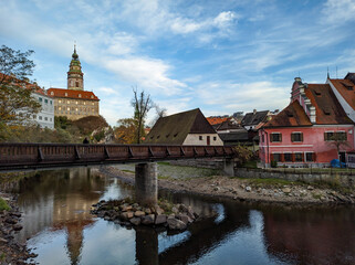 Naklejka na ściany i meble Picturesque autumn cityscape of Cesky Krumlov overlooking its historic centre and ancient Castle on bank of Vltava river, Czech Republic