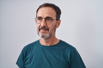 Fototapeta premium Middle age man standing with serious expression over isolated white background