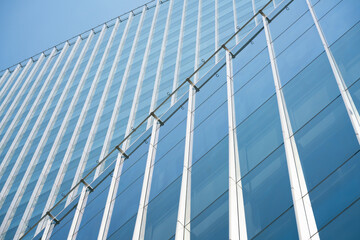 Fototapeta na wymiar close-up soft light pattern glass wall facade exterior architecture building reflection blue sky clean environment background. modern business office concept,smart city backdrop cover minimal design.