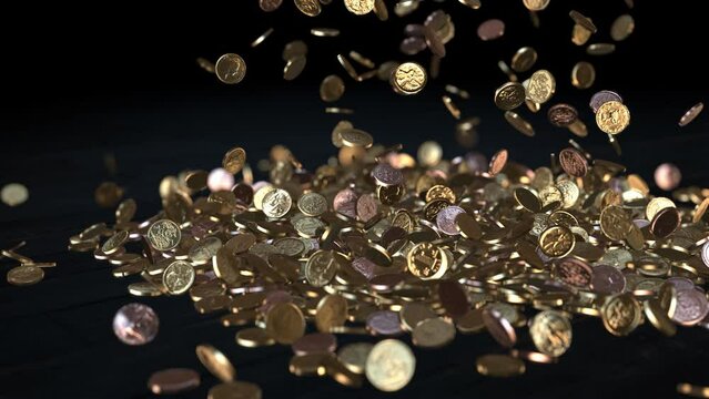 Gold and copper shiny coins are falling onto a black surface.