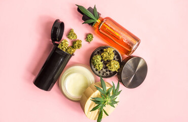 Medical cannabis or Drug, Marijuana flower buds Cannabis CBD oil, Cosmetic cream and grinder on pink background