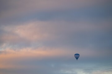 Hot ait balloon flying in the air at sunset