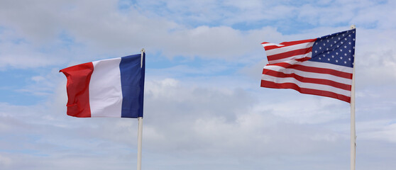 two American and French flags waving together as a sign of collaboration