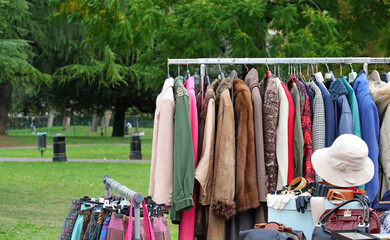 vintage used and new clothes for sale in the stall stand at the flea market