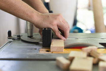 Hands of person doing diy project at home. Man measuring wood to doing cabinet craftworks as a hobby.