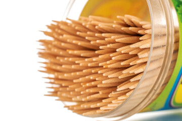 Wooden toothpicks in plastic packaging, macro, isolated on white background.