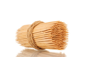 Wooden toothpicks tied with jute rope, macro, isolated on white background. - obrazy, fototapety, plakaty