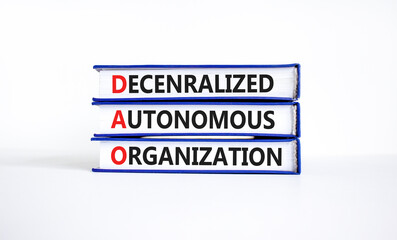 DAO decentralized autonomous organization symbol. Concept words DAO decentralized autonomous organization on books on a beautiful white background. Business and DAO concept. Copy space.
