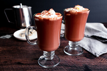 Mugs of Hot Chocolate Topped with Whipped Cream and Shaved Chocolate: Hot cocoa infused with Earl Grey tea with chantilly cream spooned on top
