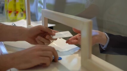 Close-up of clients hand at the reception gives his access card and receives the key 