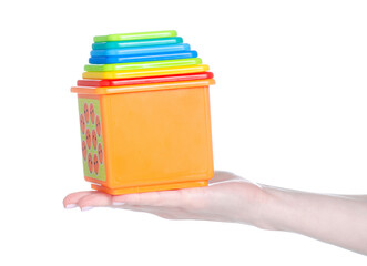 Children's toy multi-colored cubes in hand on white background isolation
