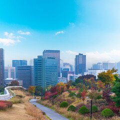 Fototapeta premium Fortress wall of Seoul city leading up to Namsan Baekbeom Plaza with autumn colorful park, Seoul, South Korea in autumn season