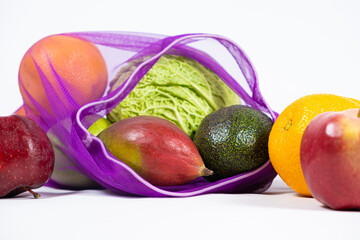 Fabric mesh for fruits and vegetables on a white background. A reusable alternative to plastic bags.