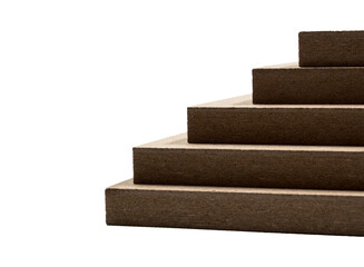 Planks made of raw mdf stacked in the form of stairs and photographed from the profile.