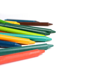 Crayons lined up isolated on white background.