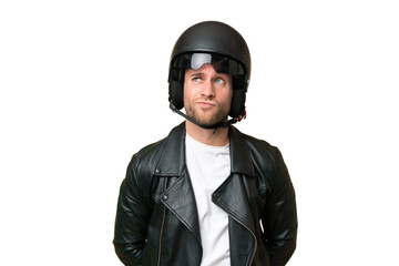Young caucasian man with a motorcycle helmet isolated on green chroma background and looking up