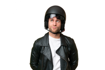 Young caucasian man with a motorcycle helmet isolated on green chroma background and looking up