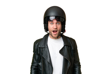 Young caucasian man with a motorcycle helmet isolated on green chroma background with surprise facial expression