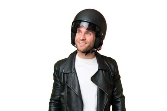 Young caucasian man with a motorcycle helmet isolated on green chroma background thinking an idea while looking up