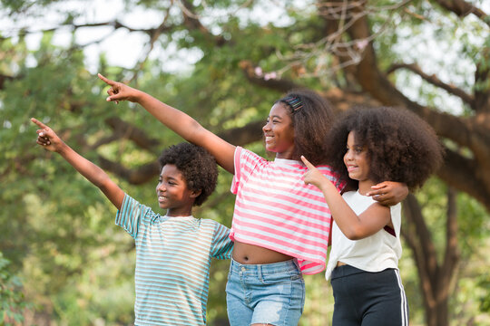 Group of African American boy and girl playing and hugging together outdoor. Happy afro children playing together in the park. Happy black people concept