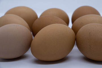 Chicken eggs of various colors on white background