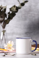 Obraz na płótnie Canvas a mug of tea is on the table. cozy work desk.