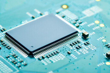 microchip on an electronic board close-up, soft focus