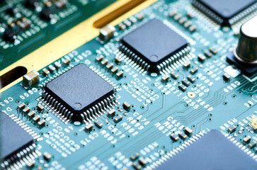 electronic board with microprocessor and electronic parts close-up, soft focus