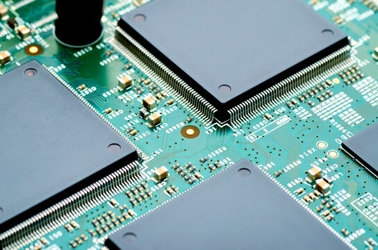 high-tech microchips on an electronic board close-up, soft focus