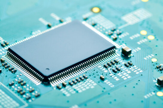 microchip on an electronic board close-up, soft focus
