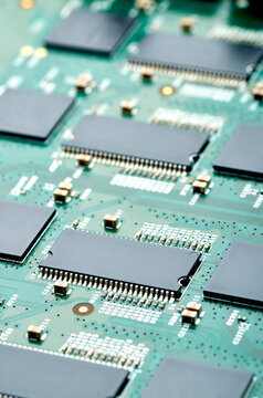 high-tech microchips on an electronic board close-up, soft focus