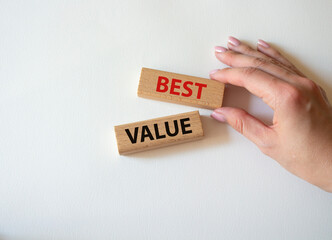 Best value symbol. Wooden blocks with words Best value. Beautiful white background. Businessman hand. Business and Best value concept. Copy space.