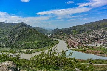 Fototapeta na wymiar The Mtkvari River flows into the Aragvi River near the Jvari Monastery, Mtskheta, April 2019. Georgia