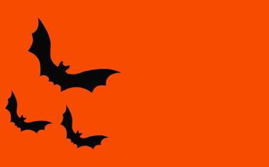 Silhouettes of bats on an orange background. Halloween