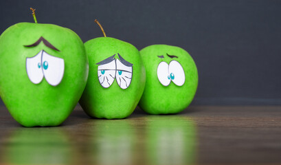 negative emotions from fear to panic, sad Face on an apple - abstract image of human emotions on blue background	
