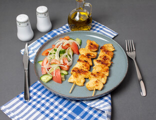 Fried greek souvlaki and salad.	