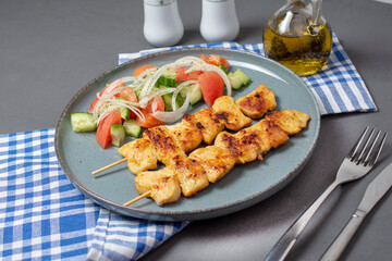 Fried greek souvlaki and salad. 