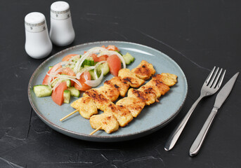 Fried greek souvlaki and salad. 