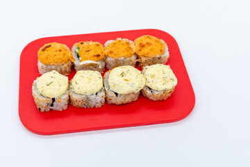 Fototapeta Set of hot maki sushi on cutting board on white background obraz