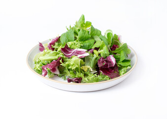 Green lettuce salad with fresh mixed vegetables isolated on white background.
