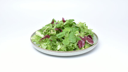 Green lettuce salad with fresh mixed vegetables isolated on white background. 