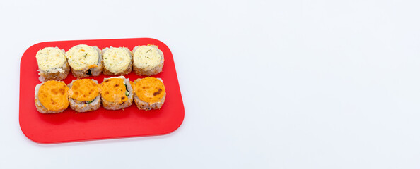 Set of hot maki sushi on cutting board on white background