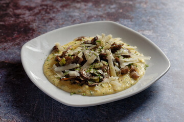 Cream polenta with fried mushrooms and parmesan cheese